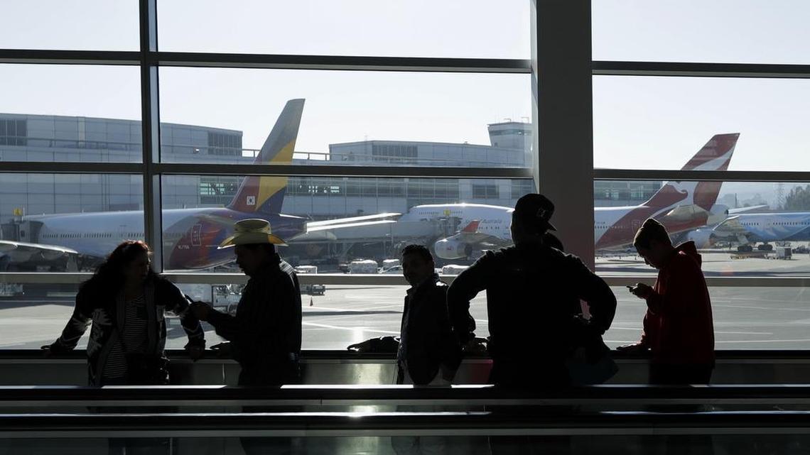 Travelers move through a terminal at San Francisco International Airport in 2016.