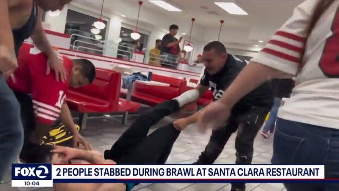 A fight involving at least 10 resulted in two stabbings at an In-N-Out, California police say. Video shows 49ers and Raiders fans fighting.