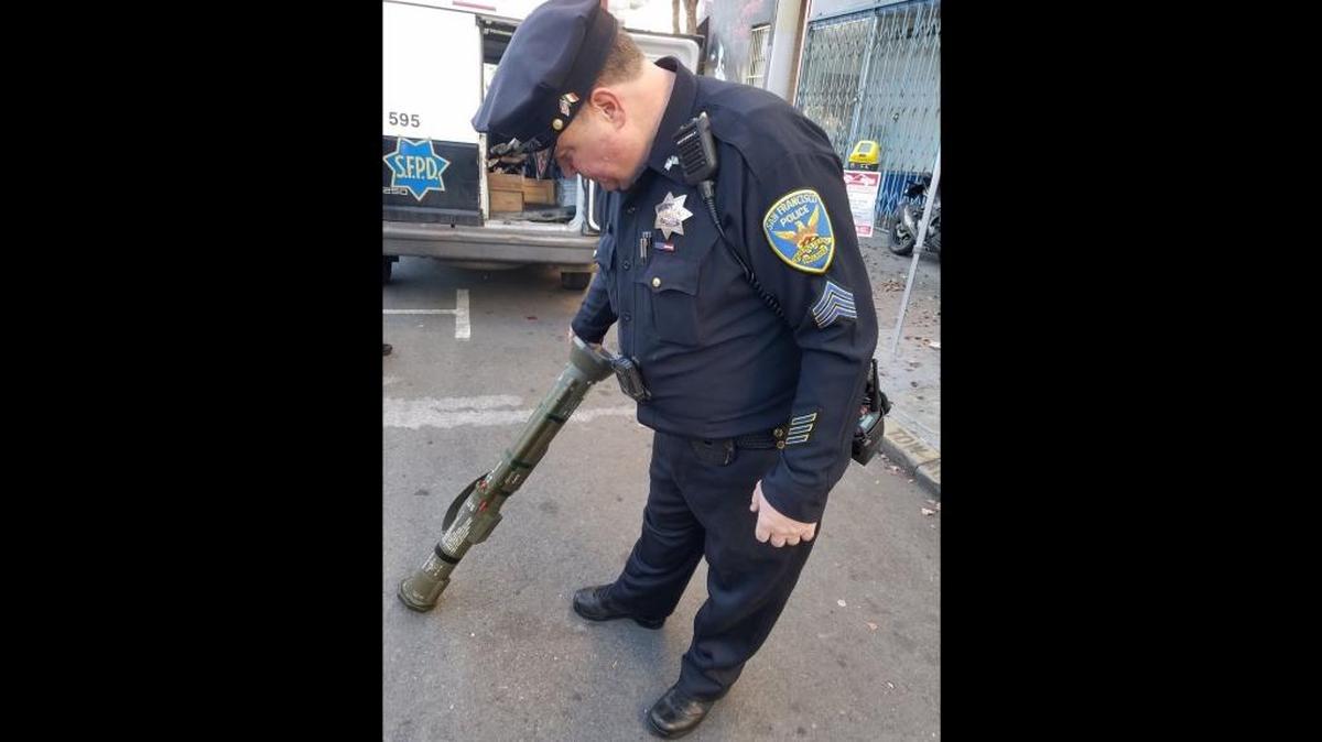 A San Francisco police officer examines a bazooka turned in during an annual gun buyback event on Saturday, Dec. 16, 2017.