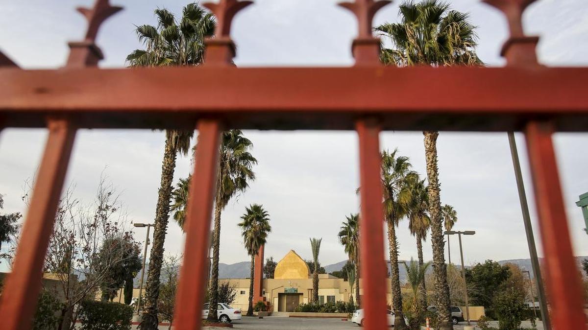 The Dar Al Uloom Al Islamiyah of America is viewed through a gate, Thursday, Dec. 3, 2015, in San Bernardino, Calif. A heavily armed man and woman opened fire Wednesday on a holiday banquet for his co-workers, killing multiple people and seriously wounding others in a precision assault, authorities said. Hours later, they died in a shootout with police.