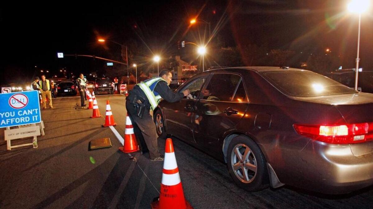 Officers check drivers at a sobriety checkpoint in Escondido in 2011. An appeals court ruled Wednesday that authorities can no longer impound a person’s vehicle for a set period of time without just cause.