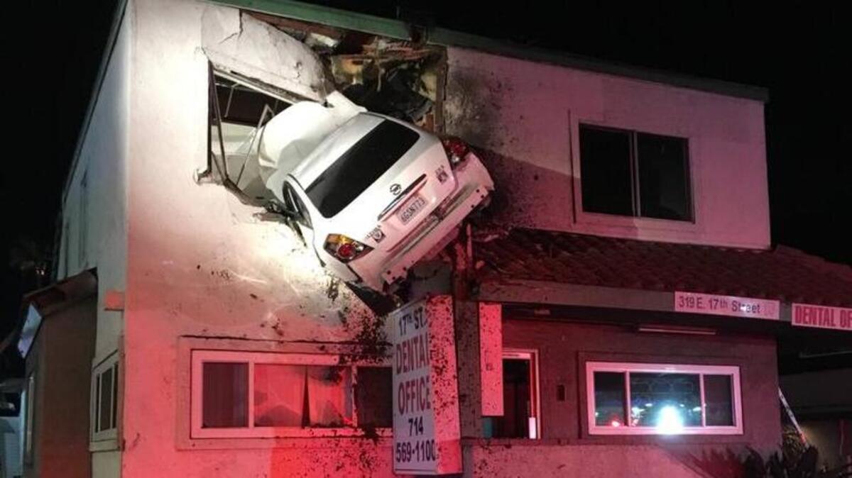 A car hit a median and flew into the second story of a building in Santa Ana on Saturday night.