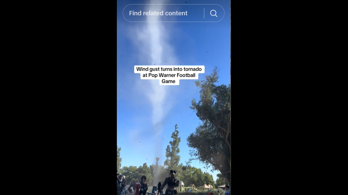 A dust devil was caught on video spiraling into the air at a youth football game.