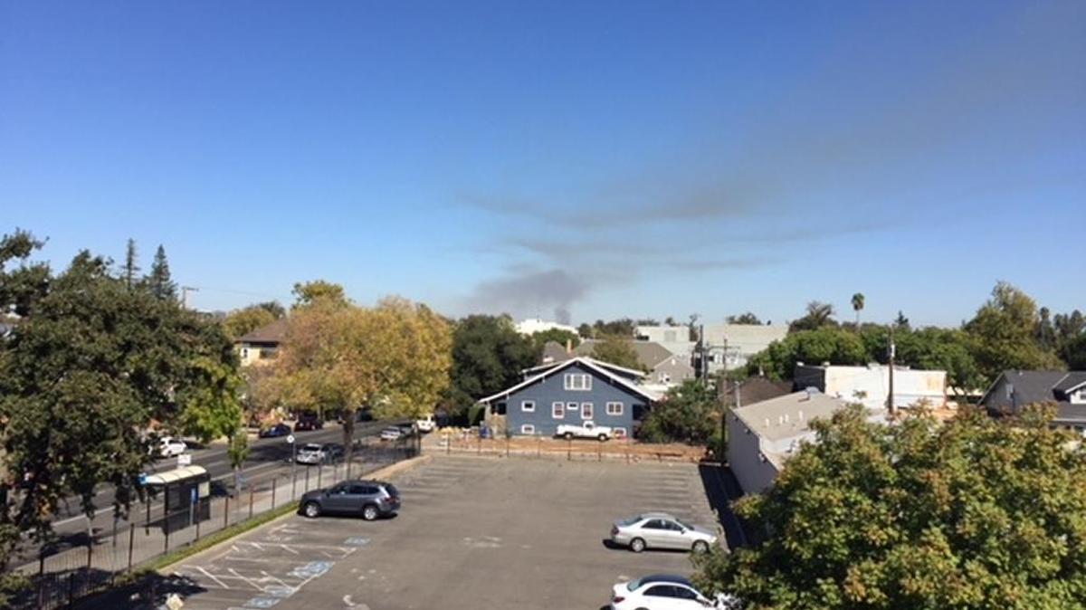 Smoke can be seen over Sacramento as the Sacramento Metropolitan Fire District and Sacramento Area Flood Control Agency burn 55 acres of brush Friday in Rio Linda.