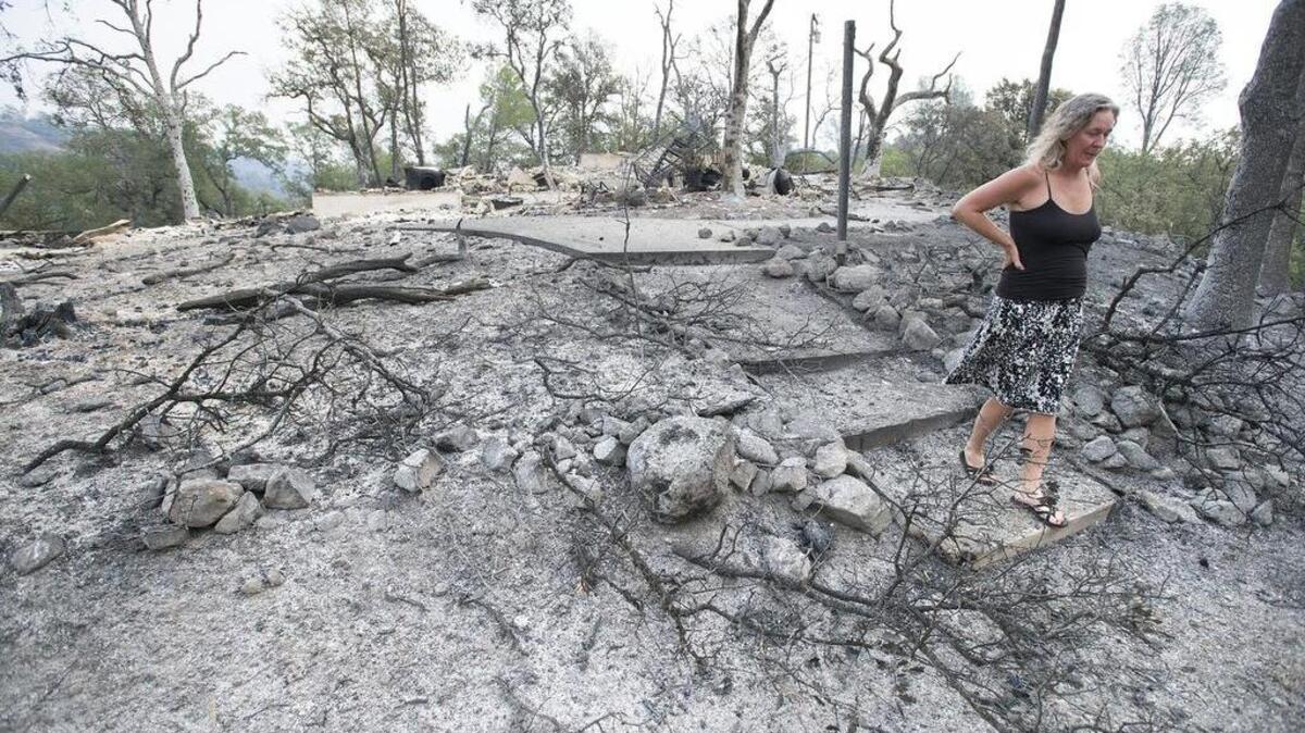 
Laura Nichols, 44, walks through the burned-out property of her best friend in Middletown on Sunday, September13, 2015, in Lake County, Calif. Her friend, Lisa Kaplan, a local artist lived in the home for 15 years.
