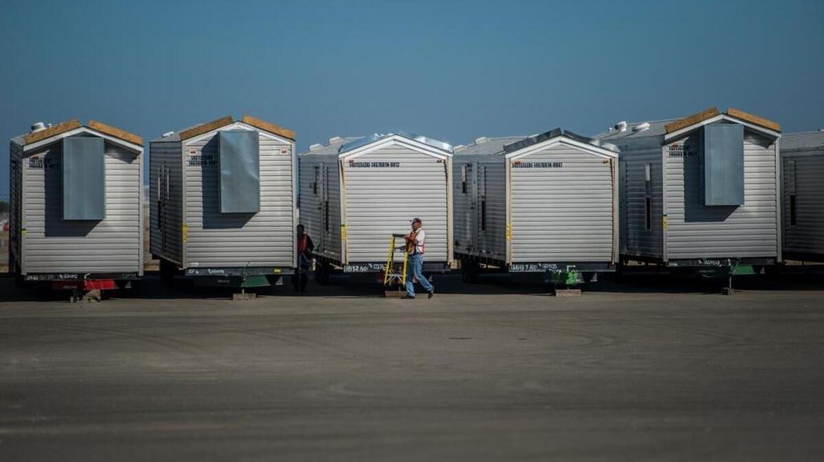 
About 60 mobile homes are clustered on the tarmac at McClellan Park, awaiting distribution to those whose homes were destroyed by wildfire.

