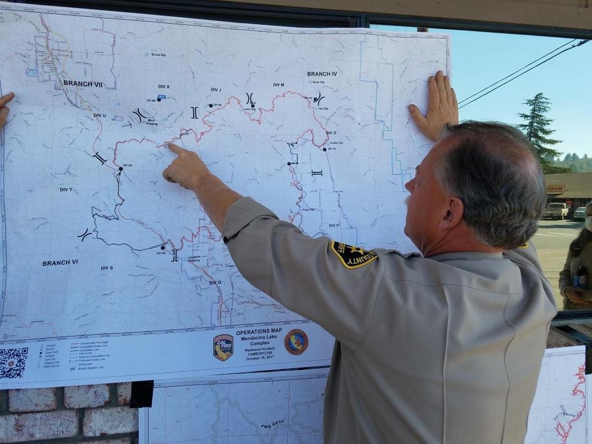 Mendocino County Sheriff Tom Allman points to a map Saturday showing the boundaries of the Redwood Valley Fire.