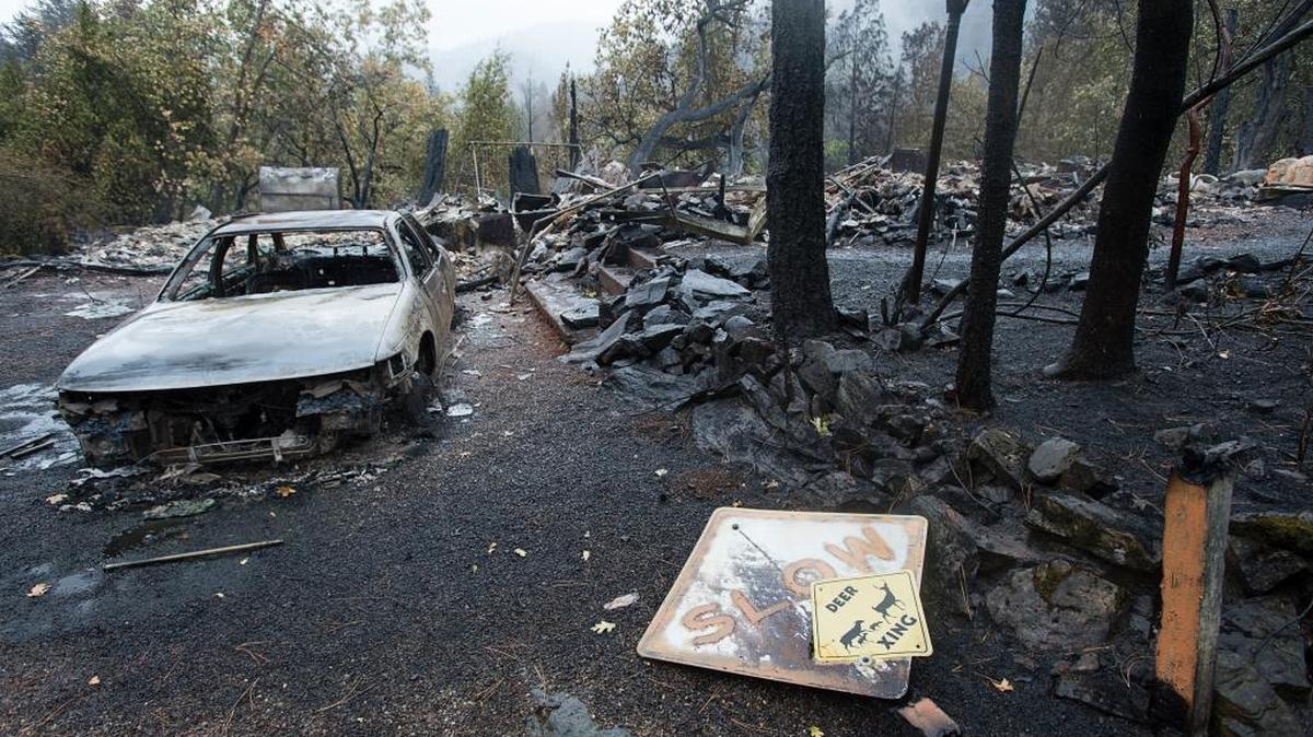 
A burned-out car sits among the rubble on Wednesday in Anderson Springs at the home of Leonard Neft, 69, who died in the Valley fire. Neft, a former police reporter for the San Jose Mercury News, last spoke with his family on Saturday evening as the fire raced through Anderson Springs.
