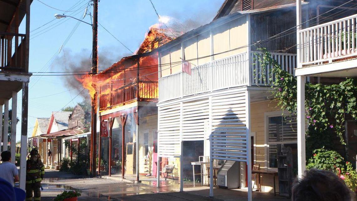 A home that sits above a knickknack shop in Locke burns Sunday afternoon. Firefighters kept the flames from spreading to other wooden buildings.