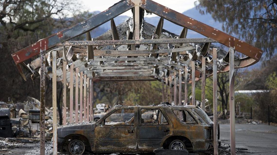
A car sits in the garage of an apartment building destroyed by the Valley Fire.
