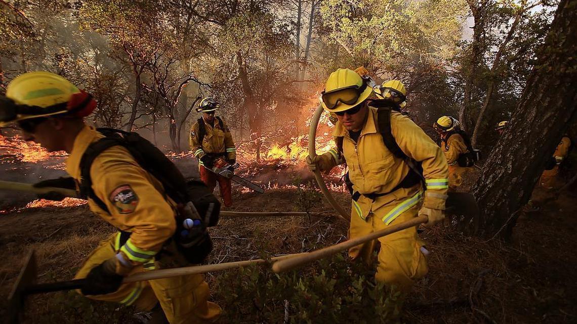 
A Cal Fire crew retreats after of a flare-up in the RockyfFire near Lower Lake on Wednesday.
