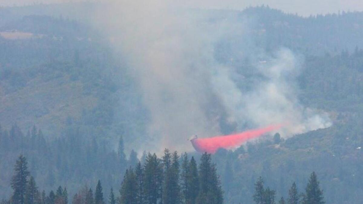 An air tanker drops retardant on the Aukum fire south of Placerville in El Dorado County on Friday, June 3, 2016. Full containment of the blaze is expected by Saturday, June 4, 2016, authorities say.