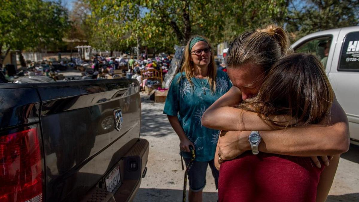 
Coral Strickler of Valley Springs embraces Kat Brenner, 18, of Mountain Ranch at the disaster relief center located at Whiskey Slide Road in Mountain Ranch. 
