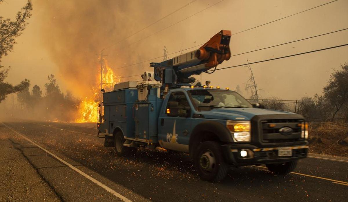 A PG&E truck makes its way past a hot spot during the Camp Fire in Paradise in November.