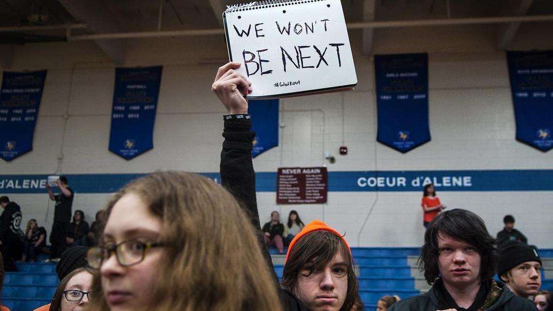 Coeur d'Alene High School 10th grader John Marfice holds his sign during the #walkout assembly at the school in Coeur d'Alene, Idaho, on Wednesday.