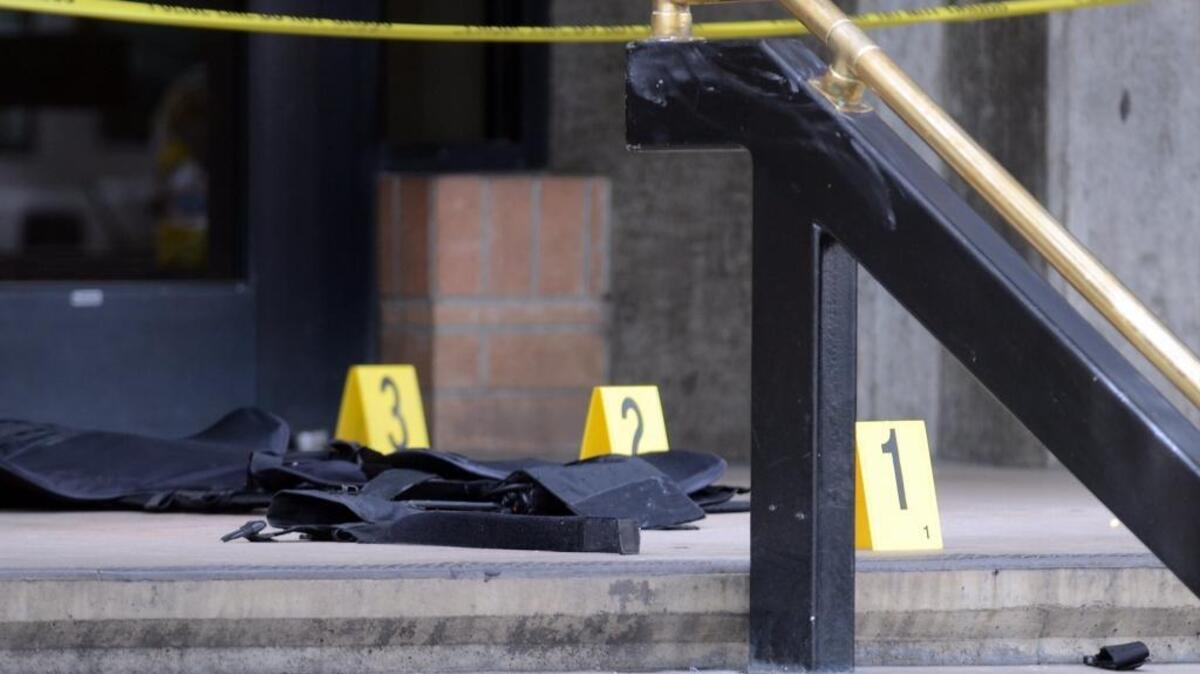 Yellow tape and evidence markers on the front steps of the Fresno County Jail after a man shot two correctional officers in the lobby Saturday, Sept. 3, 2016.