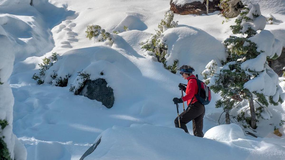 Monica Treanor of Kyburz hikes on snowshoes at Echo Summit last month. Recent storms added even more snow.