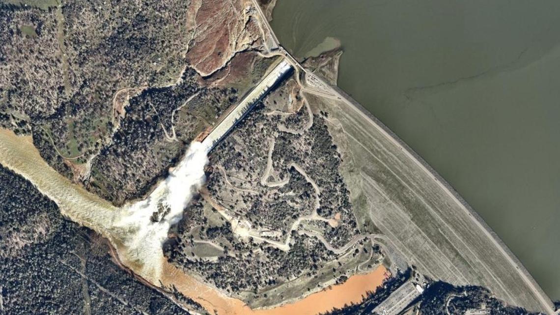 The complex relationship between nature and human need and ability to control it is illustrated by aerial photos of Lake Oroville, Oroville Dam, the dam’s spillways, the Feather River and nearby communities.