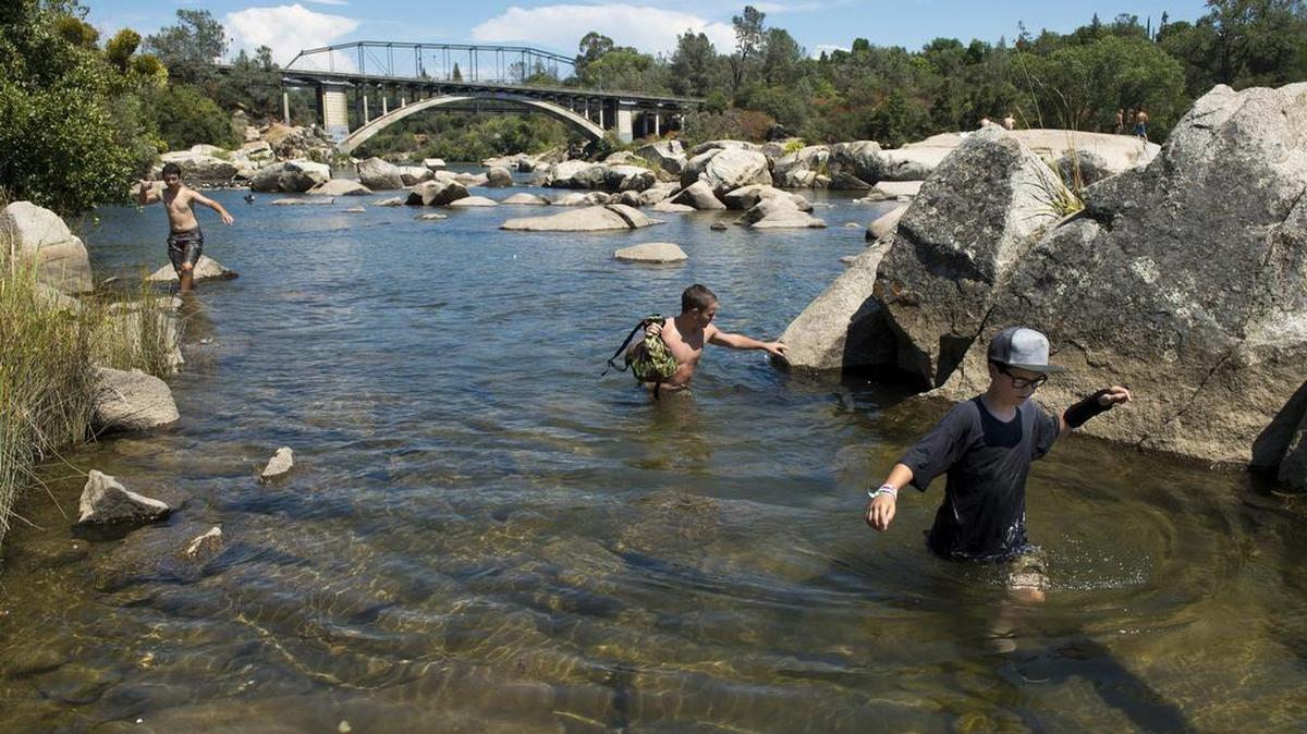 
From left, Dominic Smith, Aiden Shephard  and Blake Machado,  all age 14 and of El Dorado Hills, wade to shore around rocks exposed by the American River’s low water level near the Rainbow Bridge in Folsom earlier this summer. 


