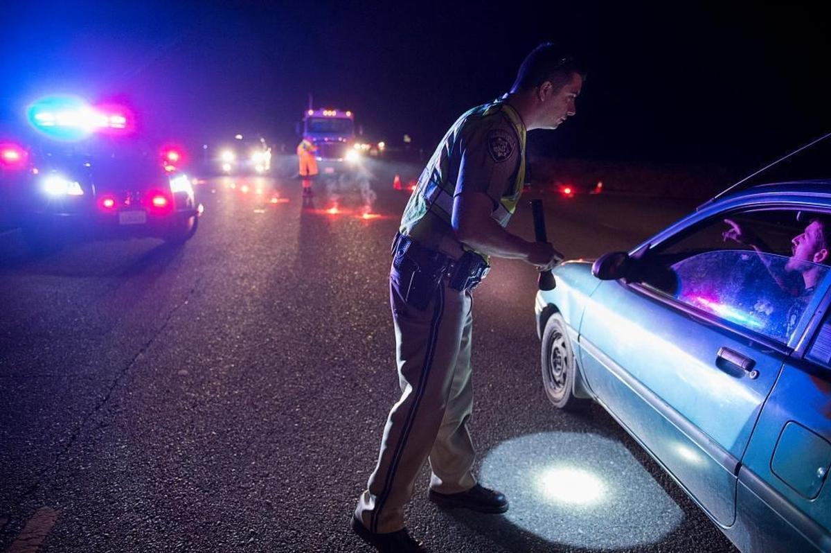 A California Highway Patrol officer, Ken Weckman, directs traffic during the Feb. 12 evacuation on Highway 70 in Marysville.