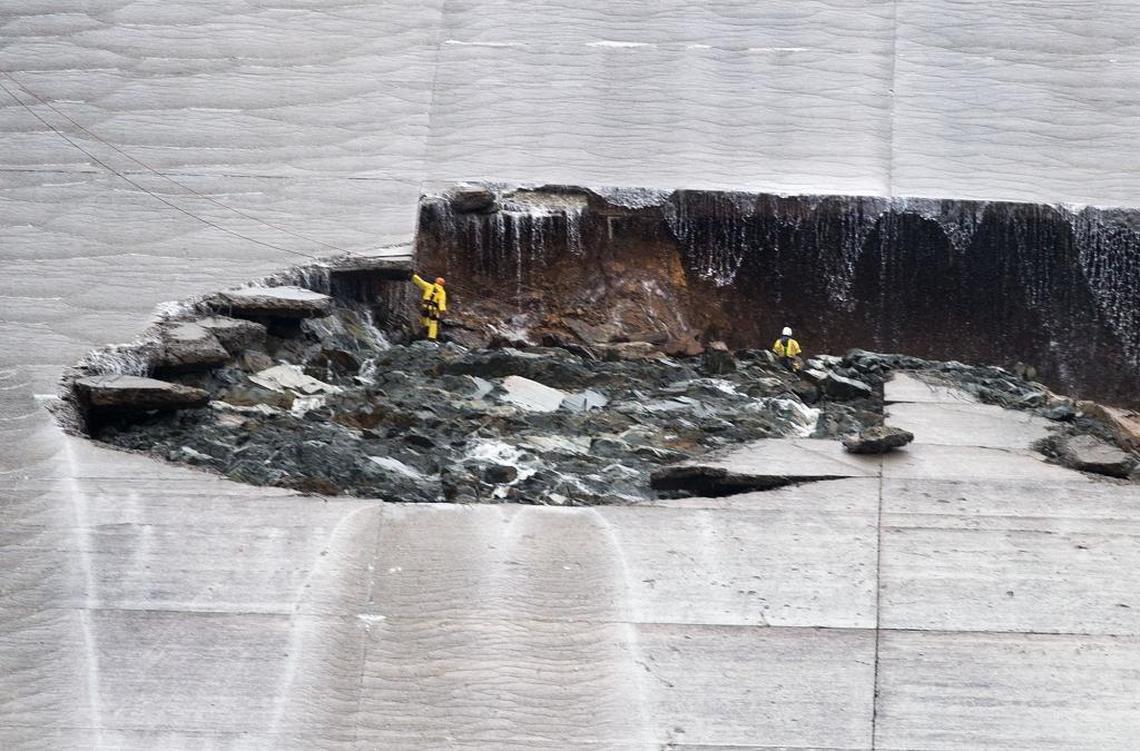 Water trickles down as workers inspect part of the Lake Oroville spillway failure on Wednesday, Feb. 8, 2017, the day after the structure cracked in two.