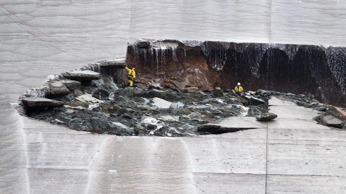 Water trickles down as workers inspect part of the Lake Oroville spillway failure on Wednesday, Feb. 8, 2017, the day after the structure cracked in two.