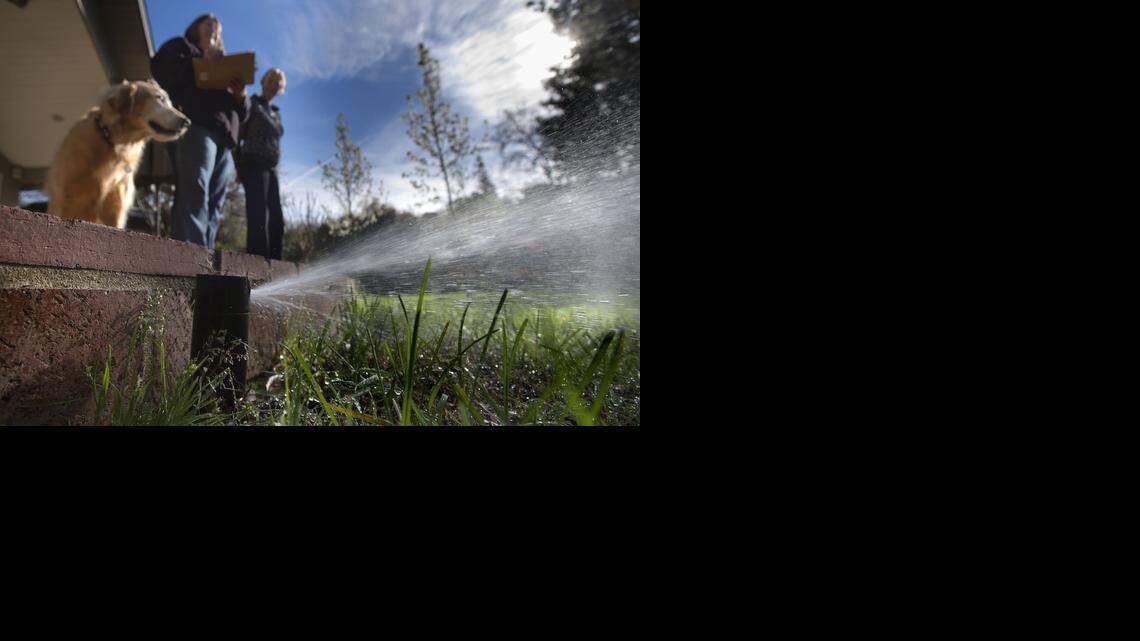 
Folsom water conservation specialist Jan Famestad, left, evaluates water usage by homeowner Ina Tompkins at her home in Folsom on March 7, 2014. Drought-caused regulations have put many restrictions on how and when residents can use water.
