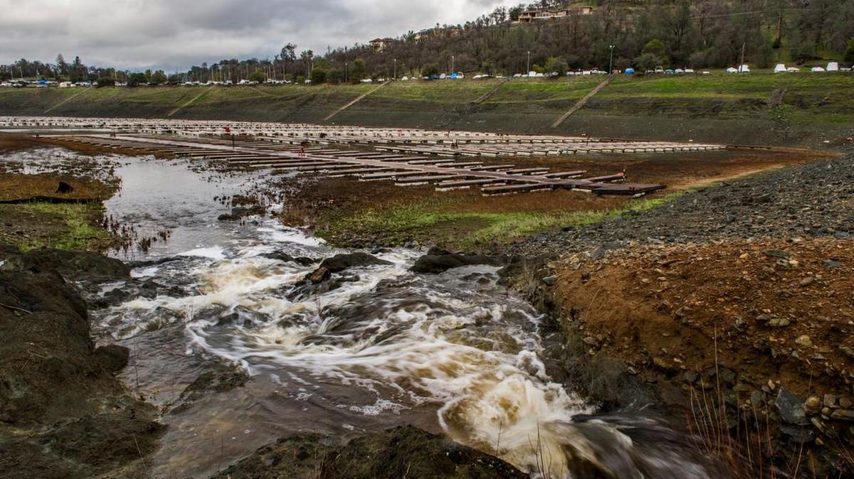 Water at last rushes down to the Brown’s Ravine Recreation Area marina on Folsom Lake on Tuesday as a storm moved through the area.