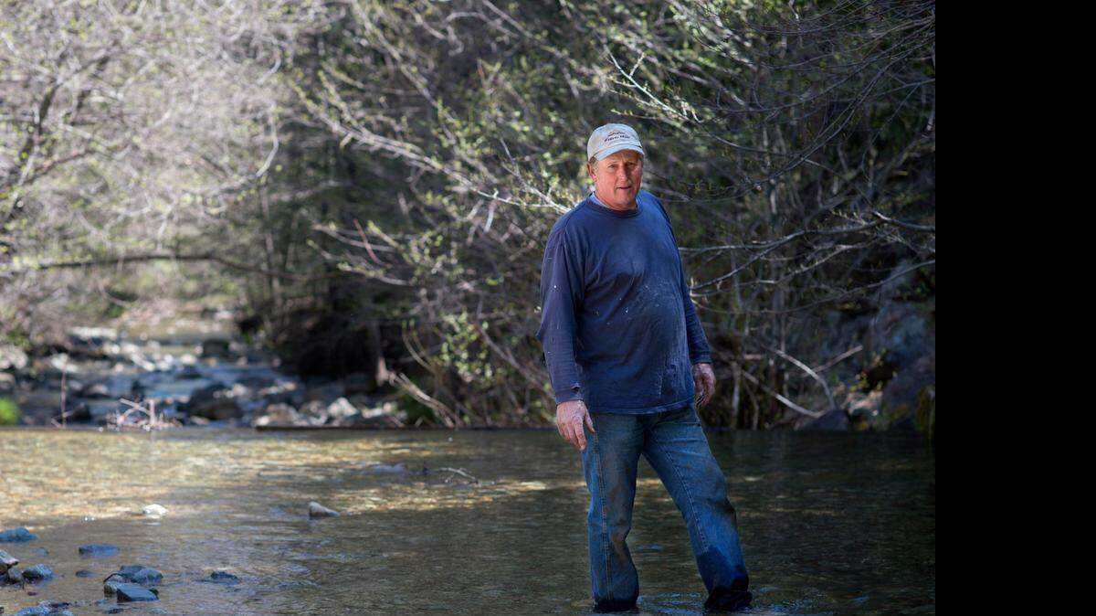 
Robert Forbes, who lives in Meadow Valley, outside of Quincy, stands in Meadow Valley Creek, which supplies water to his customers near his farm. The Forbes family runs a water utility for just 12 customers.
