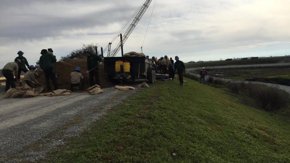 Crews work to reinforce the integrity of the levee adjacent to Tyler Island.