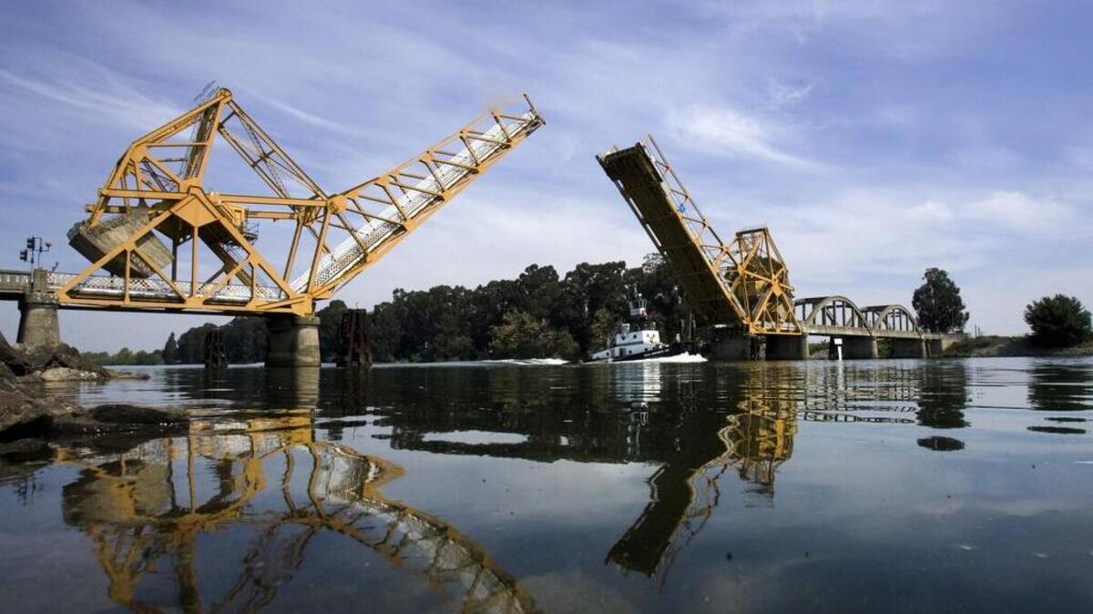 A tug passes under the Isleton Bridge.