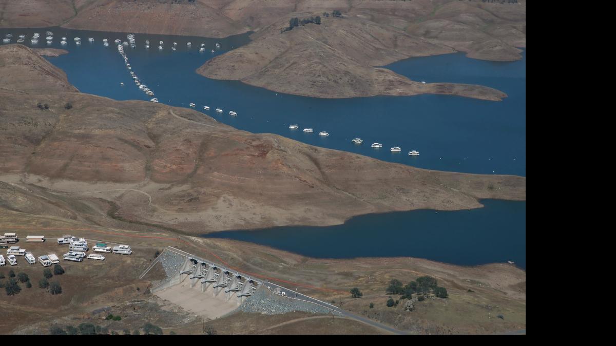In this aerial photo taken April 28, a spillway sits more than 100 yards from the water level of New Hogan Lake near Valley Springs, east of Lodi. The State Water Resources Control Board on Tuesday approved mandatory emergency regulations to protect water supplies during California’s prolonged drought.