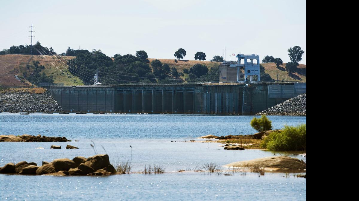 
Folsom Dam is seen from the shoreline at Beal's Point on Wednesday in Folsom. A half-million Sacramento water users nearly lost their main water source last year when Folsom Lake dropped close to the “dead pool” level, which is below the dam’s water intakes. That alarmed water officials. Now, water managers say they have a plan to reduce the chance that Folsom Lake water will become inaccessible in future droughts.
