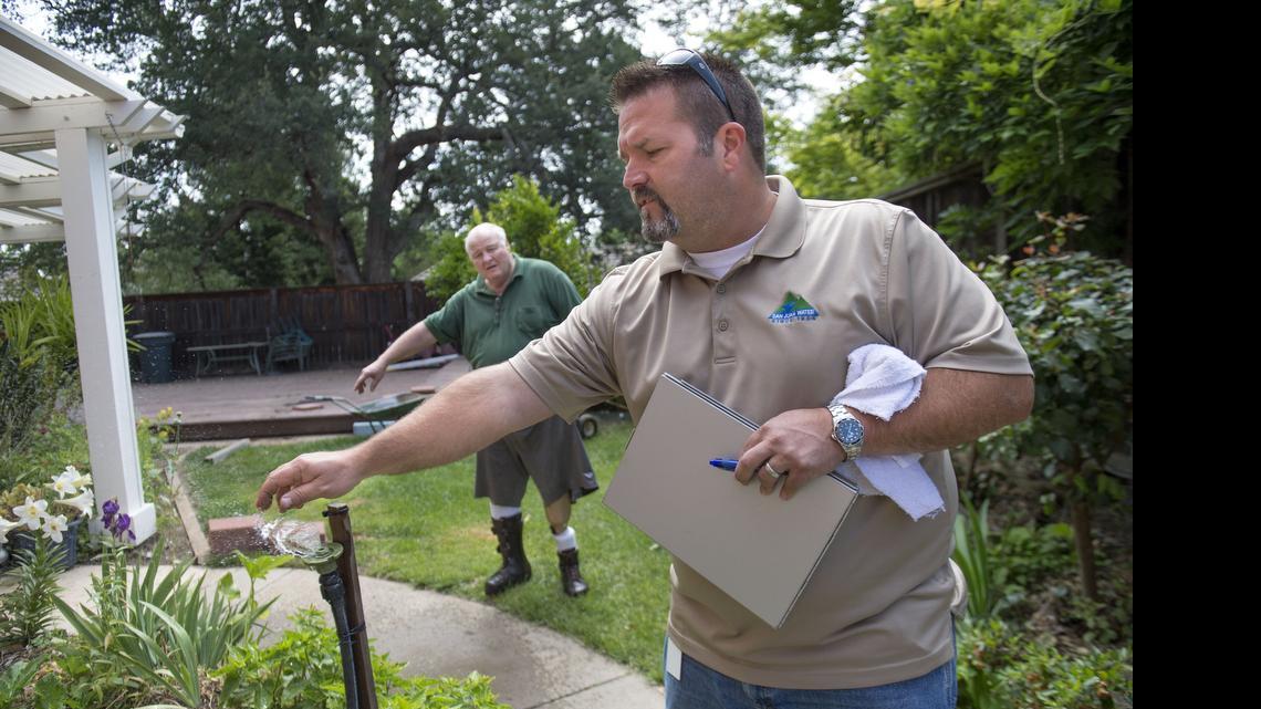 
Darren Van Dusen, a conservation technician with the San Juan Water District, checks a sprinkler at the home of Mike Singleman in Granite Bay on May 22. Sacramento-area residents reduced their water consumption in May by 40 percent compared to two years ago, the Regional Water Authority reported Wednesday.
