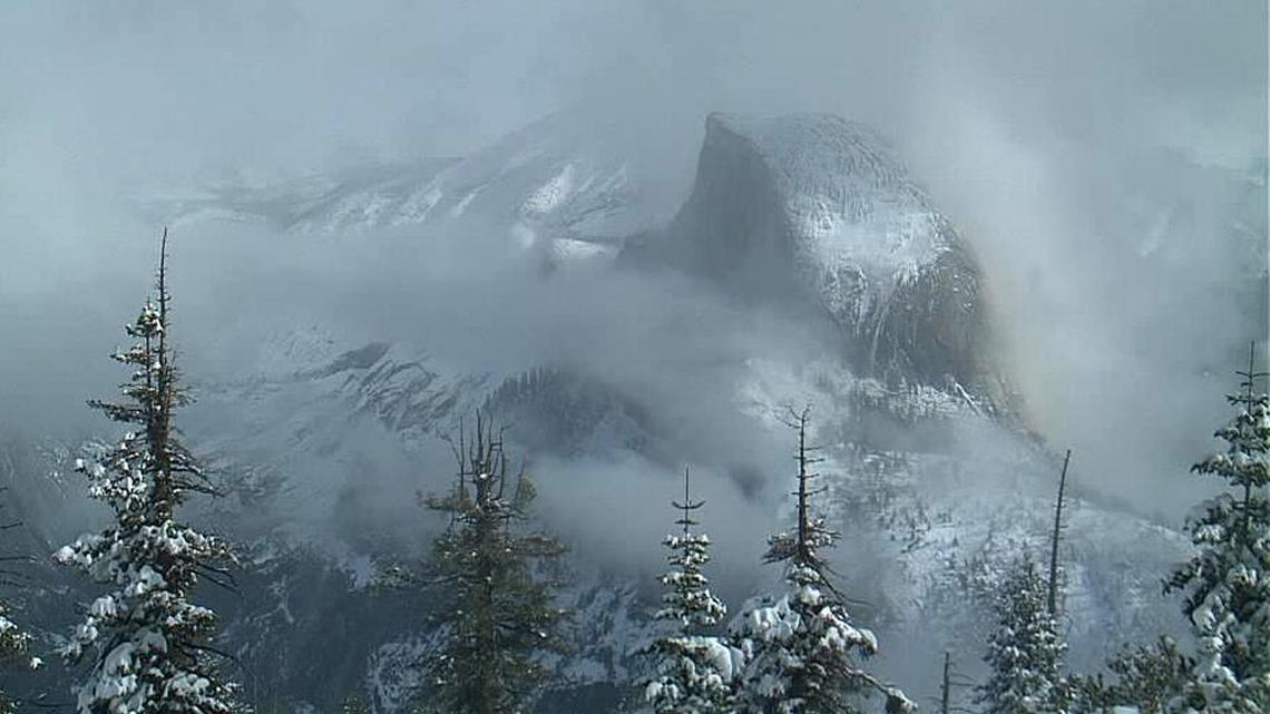 This image made from a webcam video provided by the Yosemite Conservancy shows Half Dome during a snowstorm in Yosemite National Park on Monday, Nov. 28, 2016. California has vital snow in the Sierra Nevada and positive rainfall totals in many areas after a stormy autumn weekend up and down the state, which is hoping to avoid a sixth consecutive year of drought conditions. The Sierra Nevada functions as reservoir for much of the state's water supply.