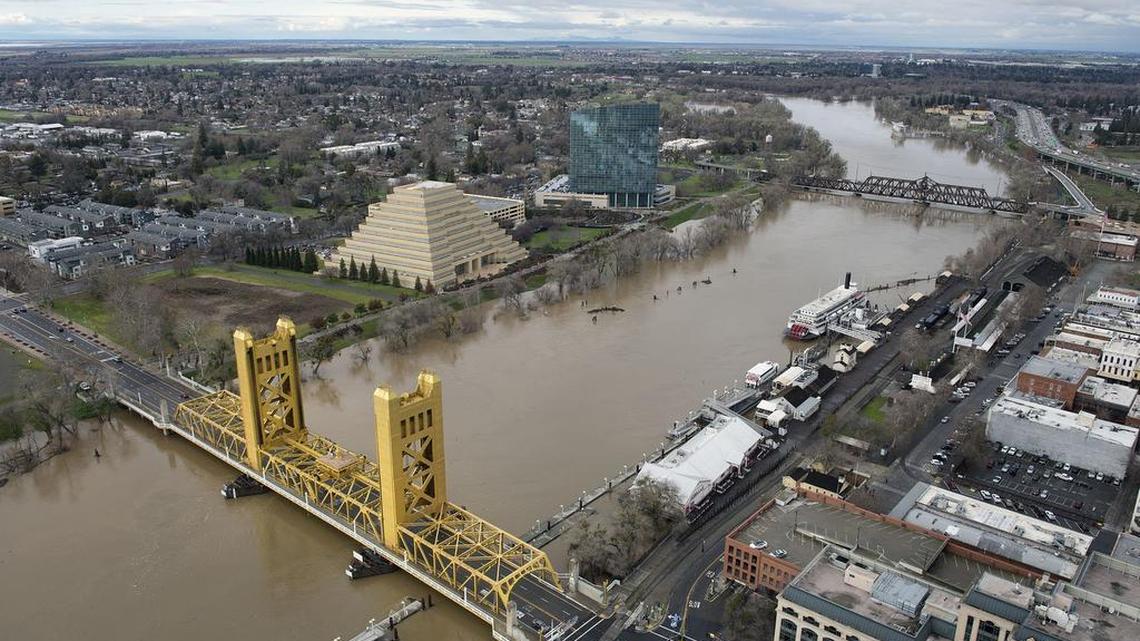 The rain-swollen Sacramento River flows through downtown under the Tower Bridge on Jan. 12 in Sacramento.