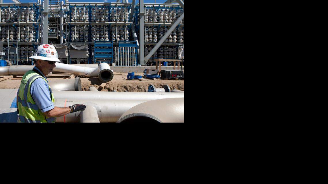 
Mike Page, site construction manager, points out the pipelines at the Carlsbad Desalination Project in Carlsbad. The reverse-osmosis membranes are in the background.
