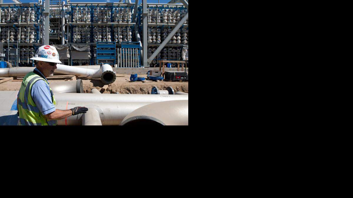 
Mike Page, site construction manager, points out the pipelines at the Carlsbad Desalination Project in Carlsbad. The reverse-osmosis membranes are in the background.
