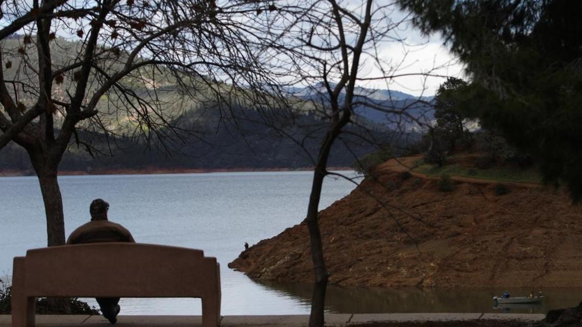 A man at the Centimudi boat ramp looks out upon Lake Shasta on March 14, 2016. Shasta and other key reservoirs have been greatly replenished during the current rainy season, improving water allocations to state customers.