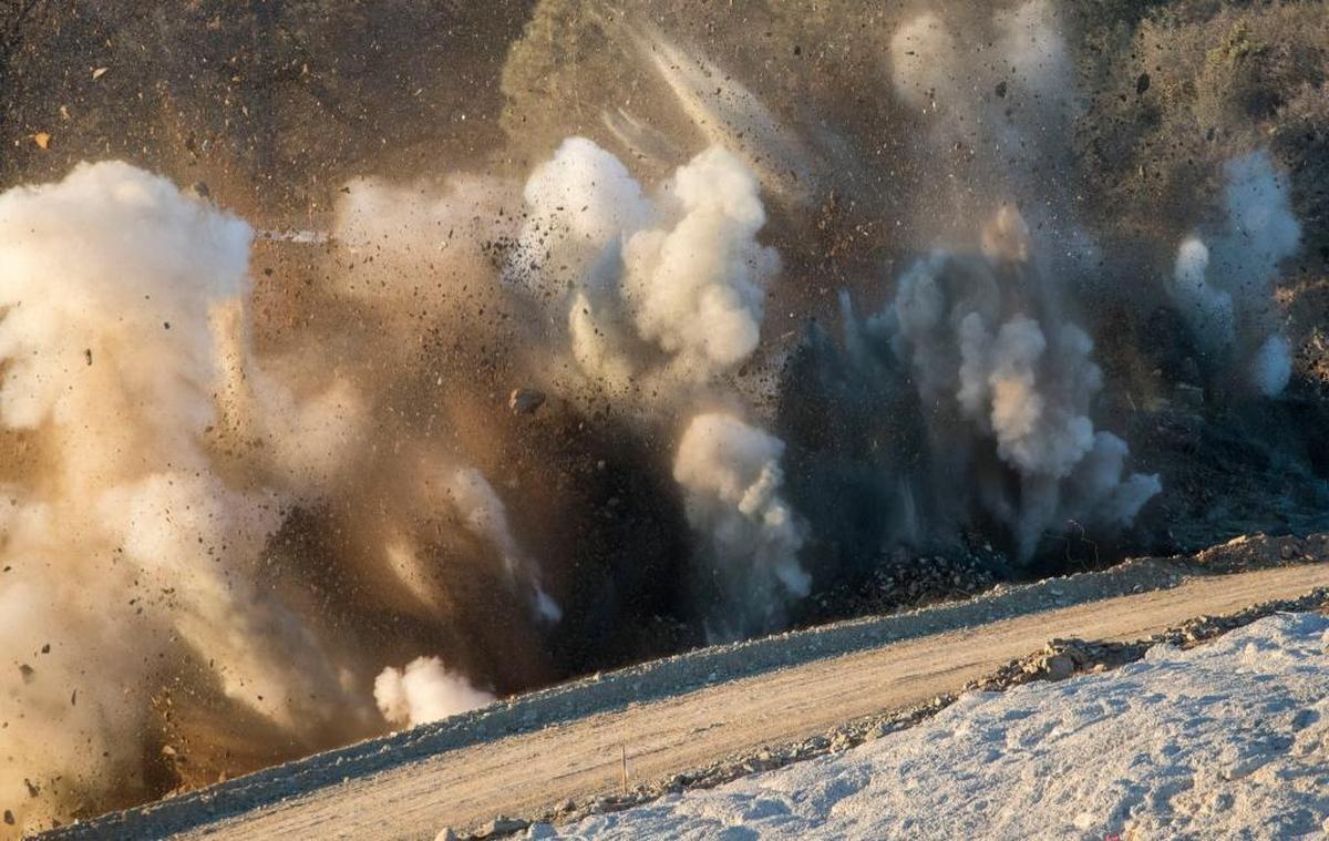 A controlled blast clears rock for the placement of concrete on the lower end of the Oroville Dam main spillway on Dec. 12.