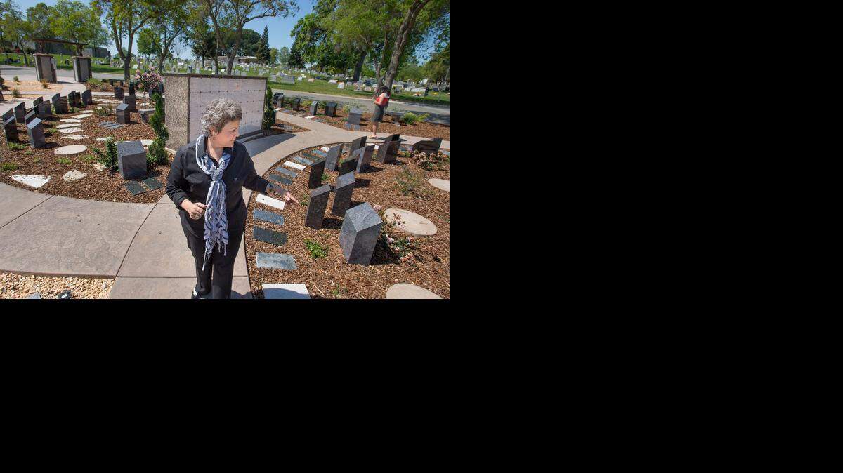 
Lisa West of Sacramento’s East Lawn Memorial Cemetery, points out drought-resistant landscaping at the El Dorado Estates area of Sierra Hills Memorial Park on Friday. Since 2013, the cemetery has watered less and, where possible, planted rock gardens and drought-resistant plants.

