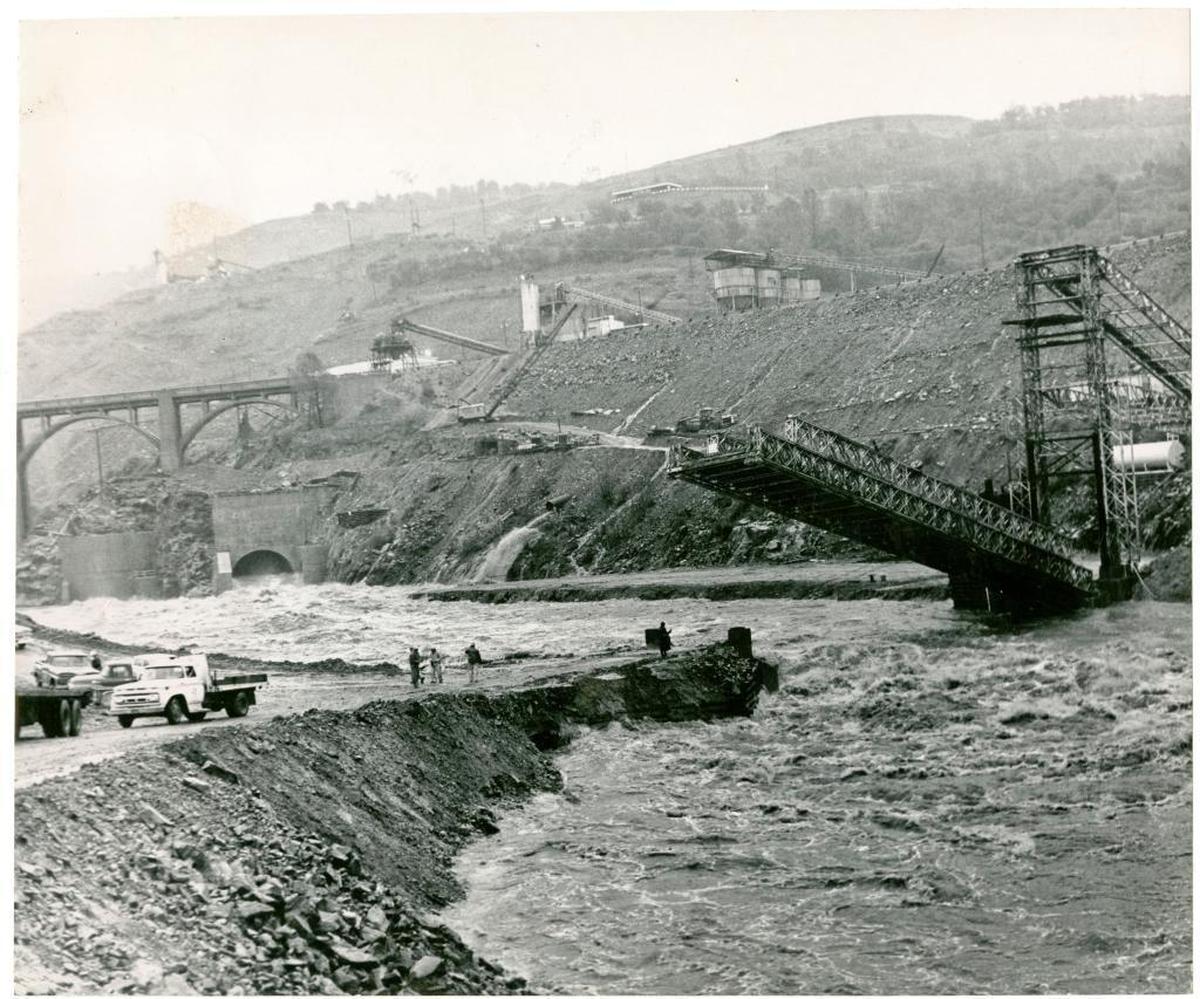 Workmen attempt to save valuable equipment from the path of the rampaging Feather River at the Oroville dam site in December 1964, when the half-built structure held back a potentially major flood.