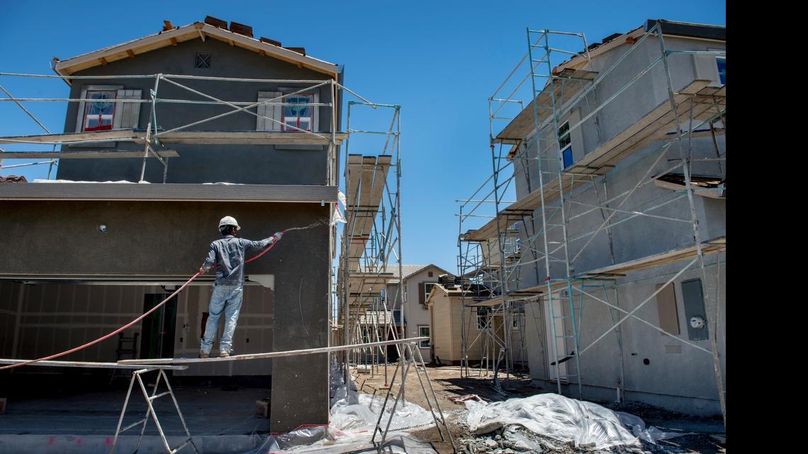 
A construction worker rinses down one of the Signature Homes houses under construction on Langford Drive in the community of Mountain House, near Tracy, earlier this month.

