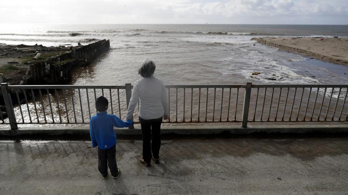 Visitors take a closer look at overflowing Aptos Creek as it flows into the sea Friday after a storm system pushed through. A $12 billion water bill could mean more water moving south out of the Sacramento-San Joaquin Delta.