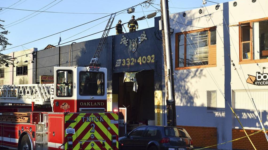 Firefighters assess the scene of the Ghost Ship fire early Saturday, Dec. 3, 2016 in Oakland. An Oakland Hills resident called police to report a black Oakland firefighter conducting routine safety inspections last month.