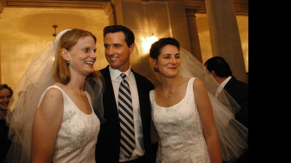 Then-San Francisco Mayor Gavin Newsom with newlyweds at City Hall in 2004. Newsom has an abiding talent for occupying the symbolic vanguard.