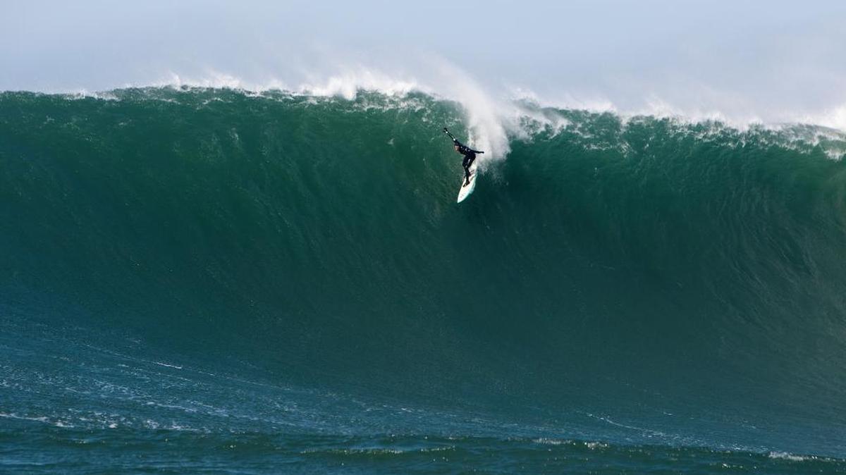 Surfer Derek Dunfee tackles a 30-foot wave at Mavericks during a perfect winter day in 2015. Big wave specialists from around the globe gravitate to the famous break located off Pillar Point on the San Mateo County coast.