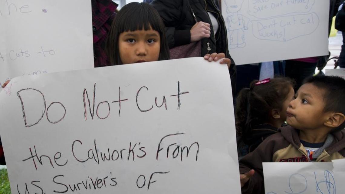 In 2012, children hold signs at a rally opposing proposed cuts to the state’s CalWORKs program. Recent budget seasons have included repeated calls to increase spending on social services programs that were cut during the recession.