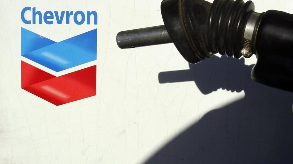 In this Jan. 27, 2011 file photo, a customer replaces the gas pump nozzle after filling the car gas tank at an Arizona Chevron station. Chevron has contributed $3.5 million to the 15 most active outside spending committees in California Assembly and state Senate races.