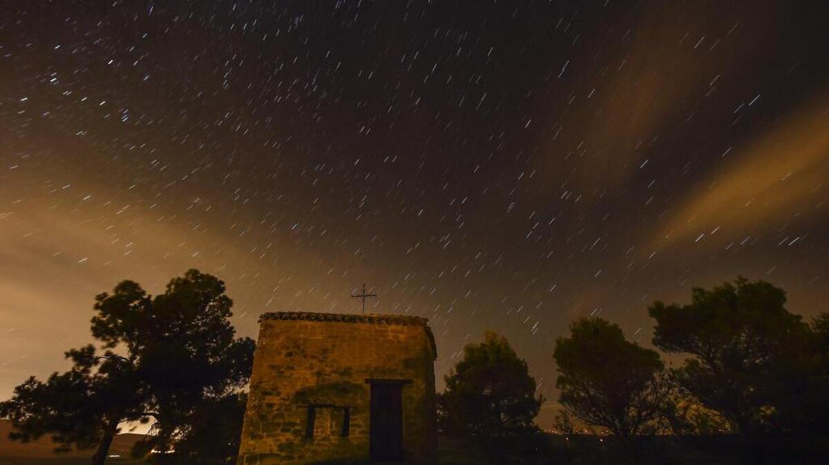 
Stars seen as streaks from a long camera exposure are seen behind Arnotegui Hermitage, in Obanos, northern Spain, Tuesday. Some Catholics refer to the Perseids as the "tears of Saint Lawrence", since 10 August is the date of that saint's martyrdom.
